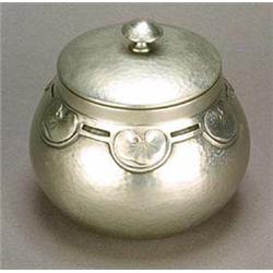 A Liberty & Co. 'Tudric Pewter' biscuit barrel, of globular shape decoraeted around the shoulders wi