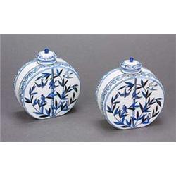 A pair of French 'Japanesque' white glass vases and covers, of moonflask shape, painted in shades of