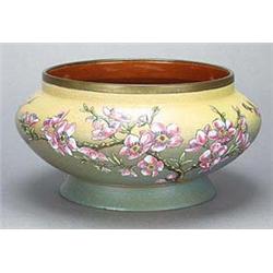 A Linthorpe pottery bowl of compressed form on spreading circular foot painted in naturalistic colou