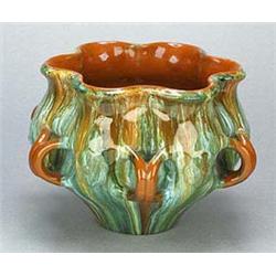 A Linthorpe Pottery jardiniere, of compressed globular shape with wavy rim and dimpled sides and app