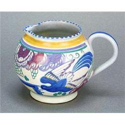 A Poole Pottery 'Blue-bird' pattern jug, the design by Truda Carter, painted in vivid colours with t