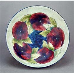 A Moorcroft large circular bowl, decorated on the interior with four large pansy blooms naturalistic