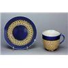 A Doulton Lambeth stoneware cup and saucer, applied with graduated rows of florets picked out in pal