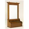 An Arts and Crafts oak wall mounted shaving mirror, with projecting top, rectangular glass and conta
