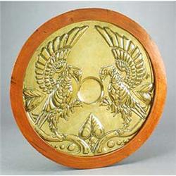 An Arts and Crafts circular brass wall plaque, showing Scottish influences, it is embossed with two.