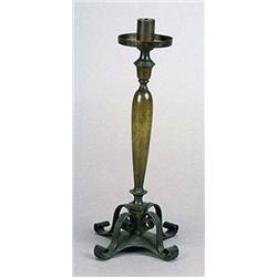 An Arts and Crafts bronze and wrought-iron candlestick, with plain sconce and drip-pan supported on.