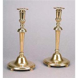 A pair of bronze candlesticks, in the manner of Lutyens, each with lobed and beaded sconces supporte