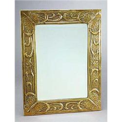An Arts and Crafts brass-faced wooden rectangular wall mirror, embossed in each corner with a butter