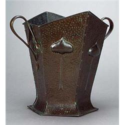 An Arts and Crafts copper log container, of flared hexagonal shape with sinuous twin handles, and ea