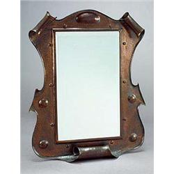An Arts and Crafts copper hall mirror, possibly Birmingham School, the frame of sinuous outline embo