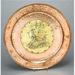 An Arts and Crafts circular copper and brass wall plaque, having a central brass panel  embossed wit