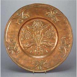 An Arts and Crafts circular copper wall plaque, by James Smithies of Wilmslow, embossed in the centr