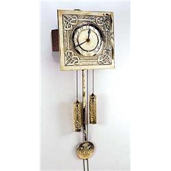 An Arts and Crafts Brass wall clock, possibly Scottish, in the manner of Margaret Gilmour, the squar