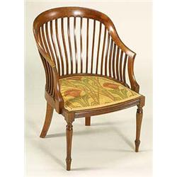 A small mahogany armchair, possibly a design by E W Godwin, with carved top-rail carved with semi-ci
