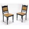 A pair of late 19th century ebonised and oak chairs, each having an ebonised shaped back rail and up