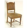 A pair of late 19th Century oak upright chairs, with curved toprail having intaglio decoration of a.