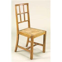Three Heals Arts and Crafts oak lattice-back upright chairs, each having a drop-in rush seat, raised