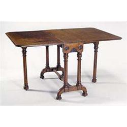 A gothic revival oak drop leaf dining table, having a short apron carved with inset roundels, raised