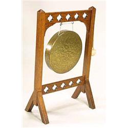 A gothic revival oak and brass gong, possibly retailed through Liberty & Co, having solid square upr