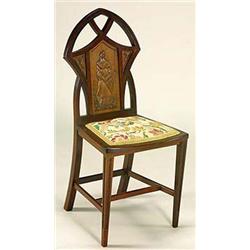 A small mahogany chair, with a back resembling the tracery of a gothic window, having a central rect