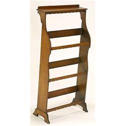 A Wylie and Lochhead oak shoe rack, with plain rectangular top shelf and plain shaped plank sides su