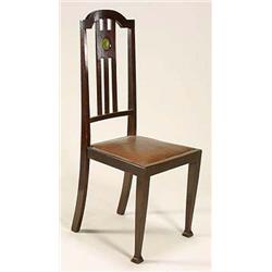 A pair of dark stained 'Scottish School' upright chairs, each having a shaped top rail on tapering u
