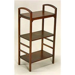 A mahogany three tier shelf unit, with curved top rails, on square supports united on the lower side