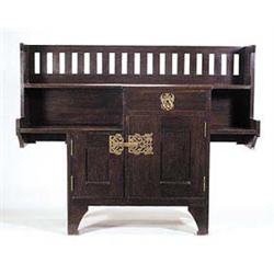 A Liberty & Co. dark oak Arts and Crafts sideboard, with broad galleried back, with groove for the d