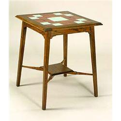 An Arts and Crafts 'Liberty Style' oak tile-topped table, the top with square oak framed inset with.