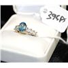 Image 2 : 10K WHITE GOLD LADIES RING WITH ONE OVAL CUT  BLUE STONE AND SIX PRINCESS CUT CLEAR SIDE  STONES
