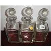 A set of three c1920's heavy glass decanters