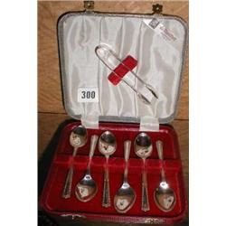 A boxed set of silver-plated tea-spoons complete with matching sugar tongs