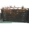 A C19th oak Arts and Crafts side board with copper relief decorated panels to doors with copper & br