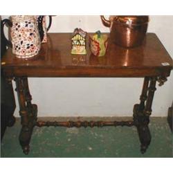 A Victorian walnut side-table with turned supports