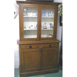 A C19th pine wood grained dresser with glazed top, shelved interior above two drawers and two door c