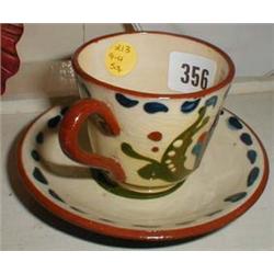 A Torquay pottery cup and saucer "Take another cup full"