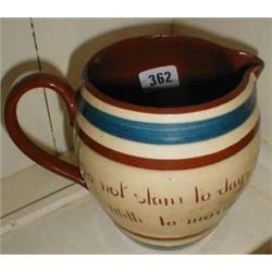 A Torquay pottery jug with cockerel pattern "Do not slain todays blue sky with tomorrows Clouds"
