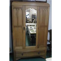 An Edwardian satin walnut wardrobe with central mirror and carved decoration, a single drawer to bas