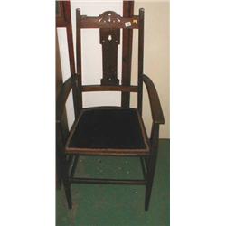 An Arts and Craft oak upholstered carver chair