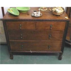 A c1930's oak two over two graduated chest of drawers