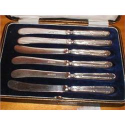 A boxed set of silver handled butter knives
