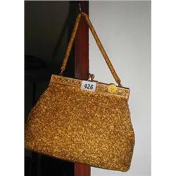 A c1950's heavily beaded gold evening bag