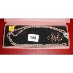 A silver rope necklace together with a silver brooch