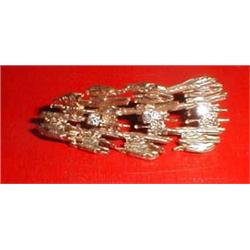 A gold and diamond bark brooch