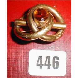 A pinch beck brooch with large yellow stone with etched decoration