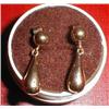 A pair of gold earrings