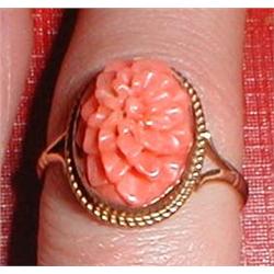A gold and coral ring