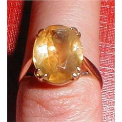 A gold ring with yellow stone