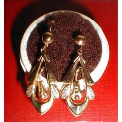 A pair of gold drop earrings