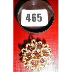 An 18ct gold brooch with Amethyst stones